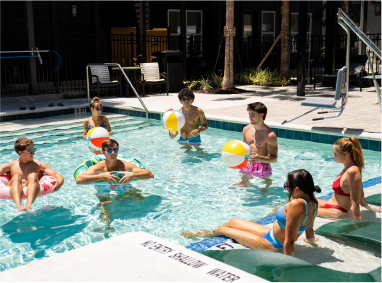 a group of young adults in a swimming pool